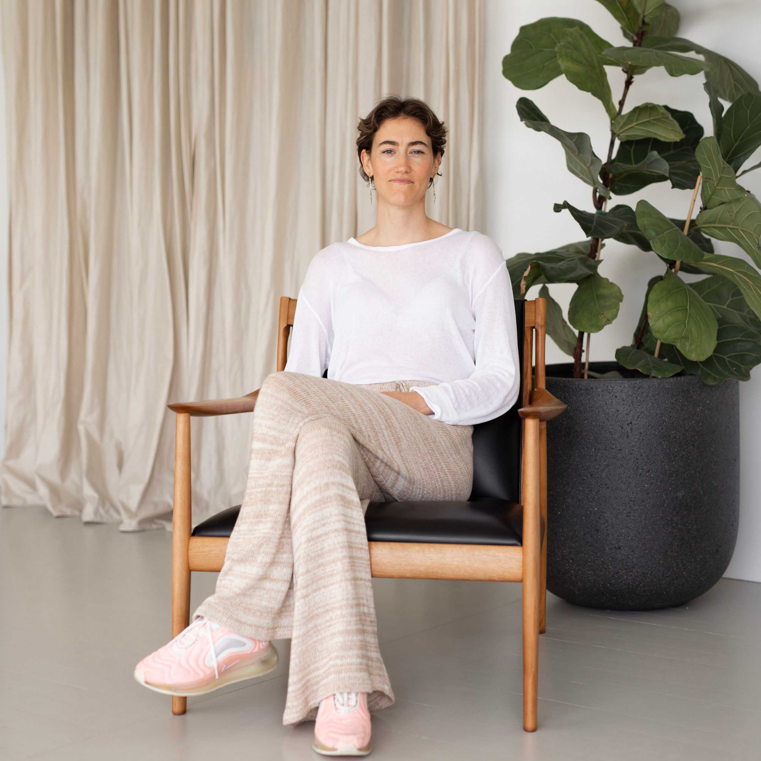 Elle seated by plant